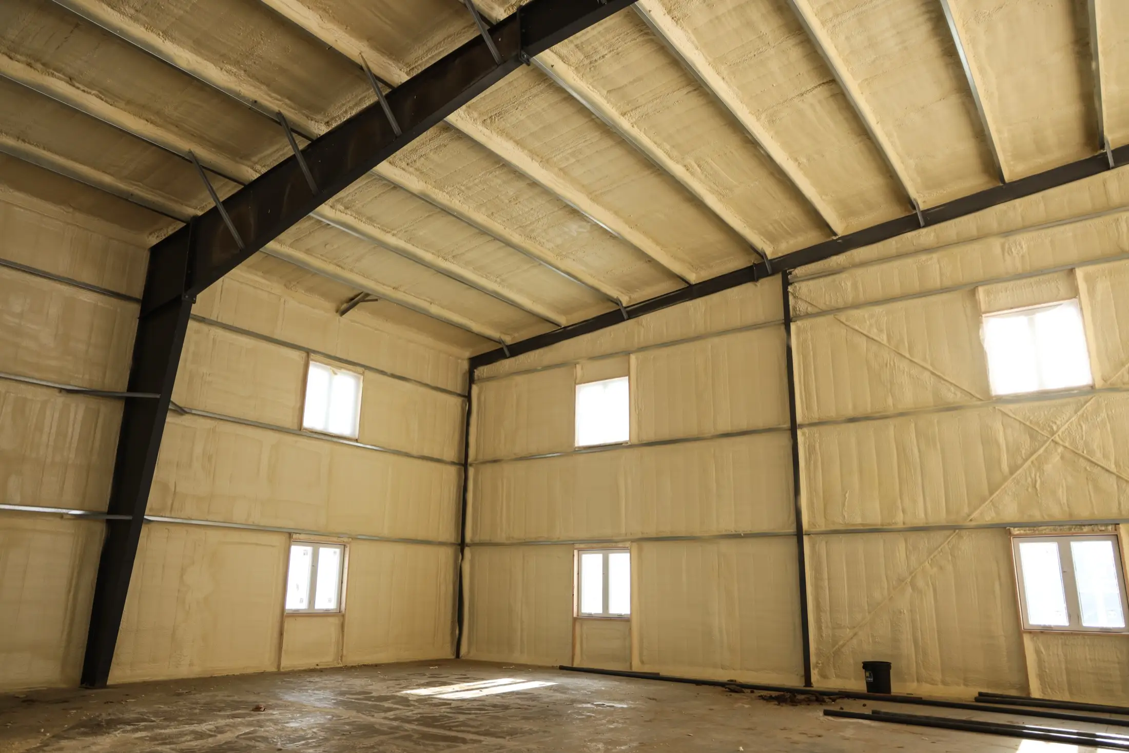 Wall cavity spray foam insulation application