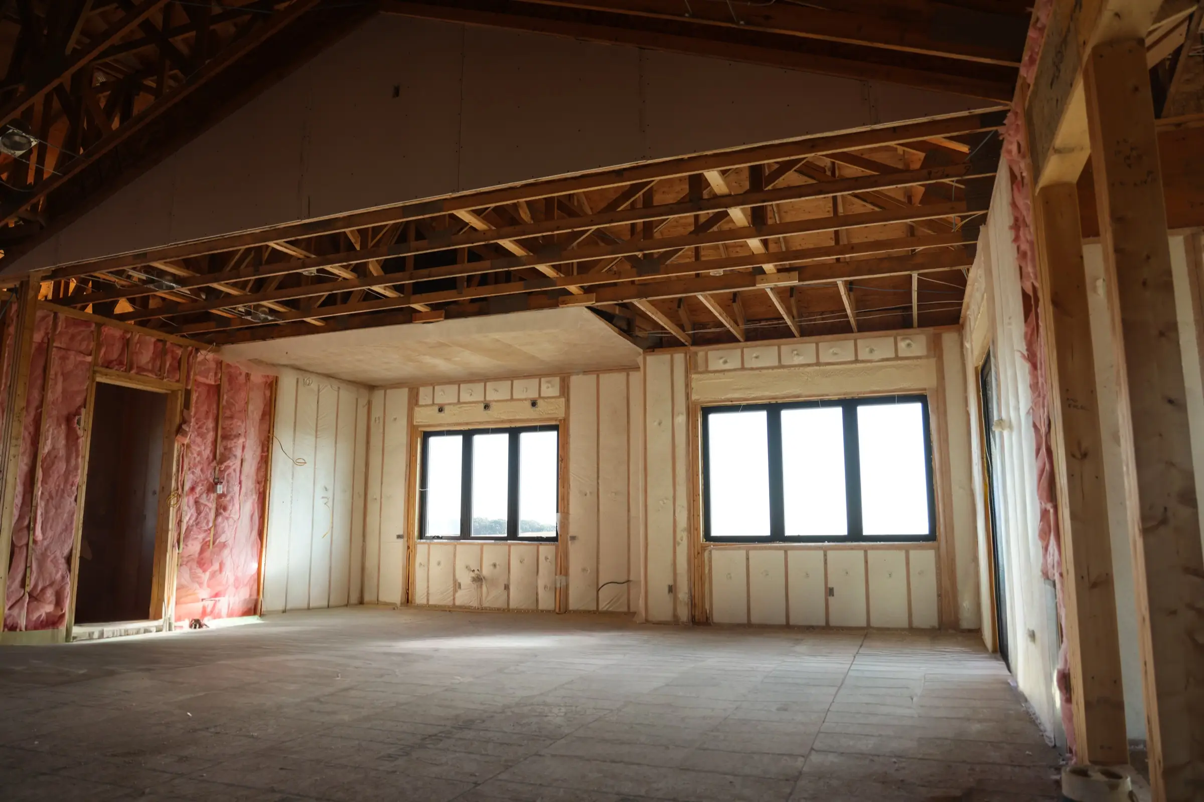 Professional installer applying spray foam insulation in a Wichita building
